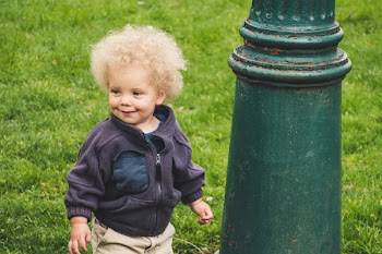 Toddler Wearing Jacket Beside the Light Post