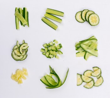 Top view cucumber sliced and chopped on white  horizontal Free Photo
