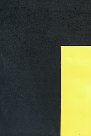 Top view Of A Yellow Flat Metal On A Dark Gray Surface
