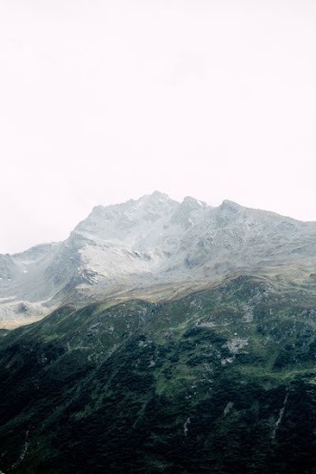 top view of mountain under white sky