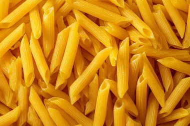 Top View of Uncooked Yellow Penne Pasta Top View of Uncooked Yellow Penne Pasta
