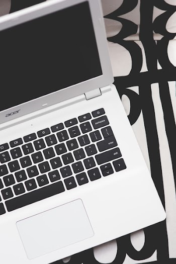Top view of white Acer laptop with black keyboard