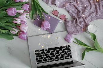 Top view on workplace with purple tulips