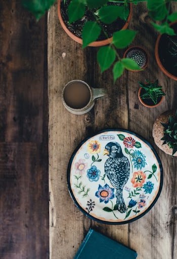 top view photo of black and multicolored bird painting with flower theme