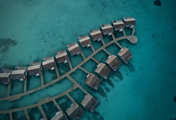Top View Photo Of Cabin On Body Of Water