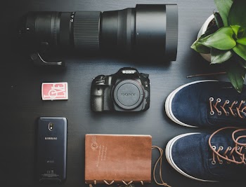 Top View Photo of Camera Near Shoes