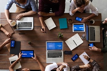 Top View Photo Of People Near Wooden Table · Free Stock Photo