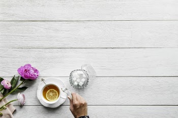 Top View Photo of Person Putting Sugar Cubes On Cup