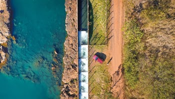 Top View Photo of Person Standing Beside Vehicle