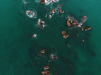 Top View Photo of Rock Formations on Water