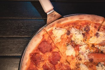 Top View Photo Of Sliced Pizza