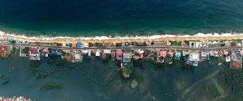 Top View Photo of Village Near Shoreline