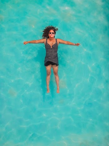 Top View Photo of Woman Floating on Water