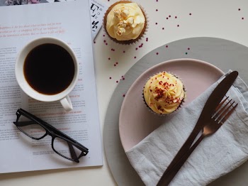 Top-view Photograph of Two Cupcakes, Cup, and Eyeglasses