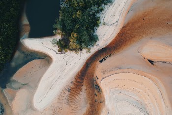Top View Photography of Island With Trees Beside Large Body of Water
