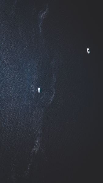 top view photography of two white boats on water at daytime