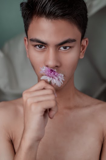 Topless Man Holding A Flower