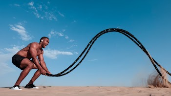 Topless Man Holding Black Rope
