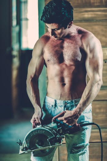 Topless Man Holding Gray Circular Saw