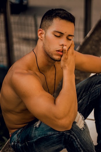 Topless Man Holding His Cheek