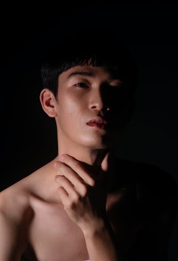 Topless Man Holding His Neck