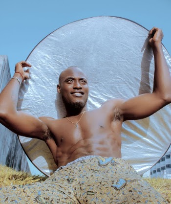 Topless Man Holding Sun Cover