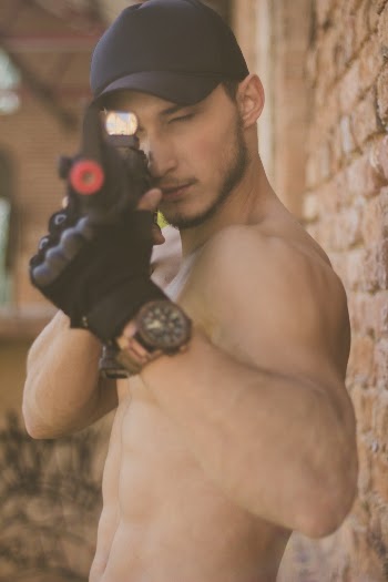 Topless Man Holding Toy Gun