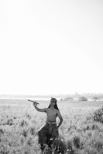 Topless Man in Black Shorts Standing on Grass Field · Free Stock Photo