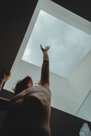topless man raising left arm