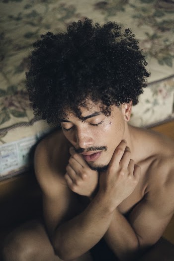 Topless Man Sitting On The Floor