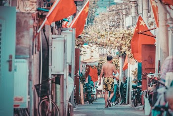 Topless Man Walking Near Street