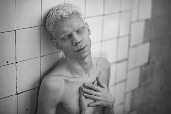Topless Man With Both Hands on Chest