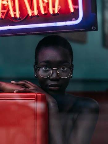 topless woman leaning on chair