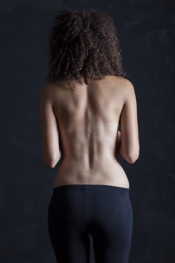 Topless Woman Standing Facing the Wall