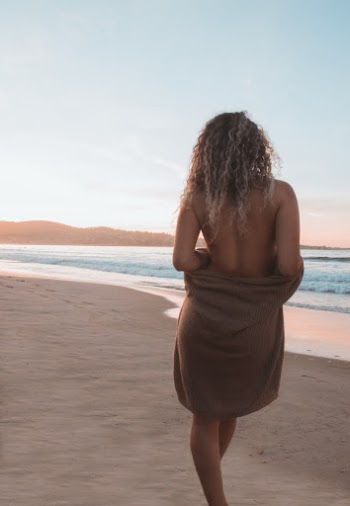 Topless Woman Standing on Beach