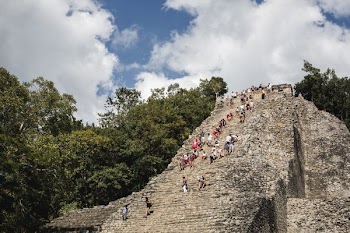 Tourists Climb Mexican Ruins