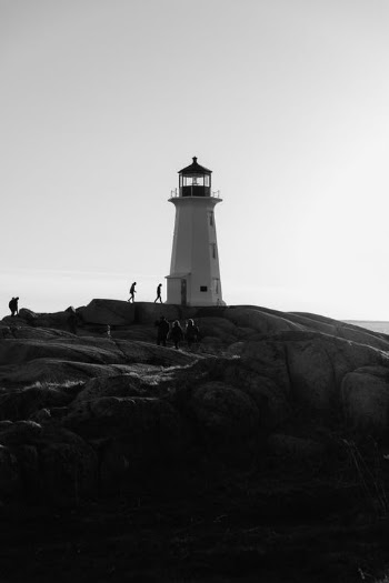 Tourists Walking Towards a Lighthouse  · Free Stock Photo