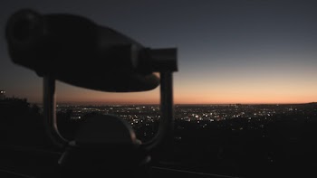 Tower Telescope in Front of Cityscape