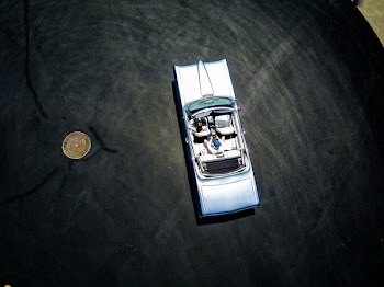 toy car near coin on table top