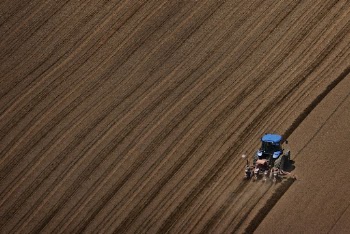 Tractor ploughing soil in a field | Free Photo - rawpixel