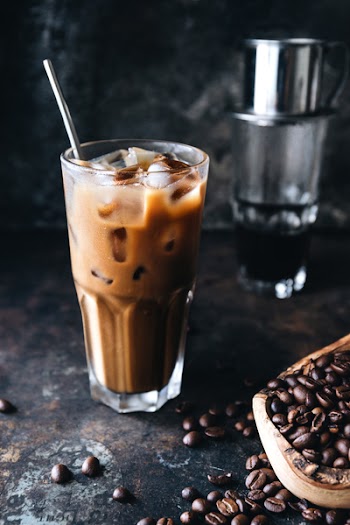 Traditional Vietnamese milk coffee on rustic background