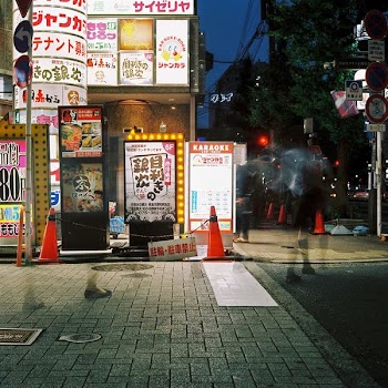 traffic cones beside kanji text signage boards