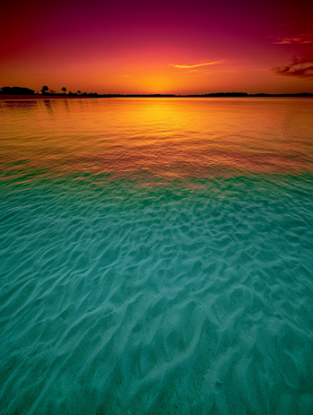 Tranquil Tropical Sunset Over Crystal Clear Waters