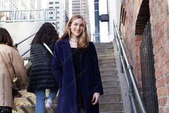 Trans woman posing on stairs outside.