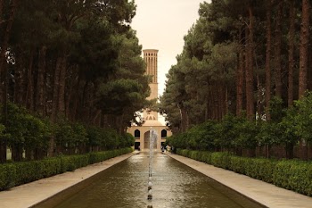 Trees Near Brown Concrete Building and Outdoor Fountain