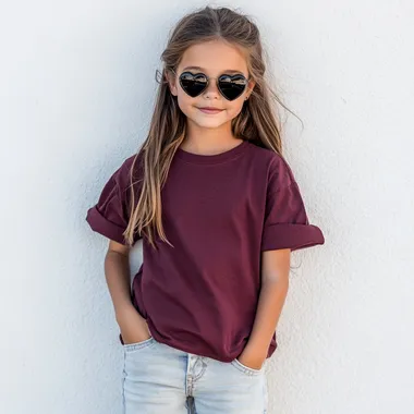 Trendy 9-Year-Old Girl in Maroon Oversized T-Shirt and Denim Jeans Trendy 9-Year-Old Girl in Maroon Oversized T-Shirt and Denim Jeans