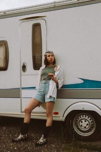 Trendy model in boots leaning on trailer · Free Stock Photo