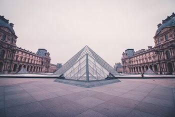 Triangular Landmark Surrounded by Brown Buildings