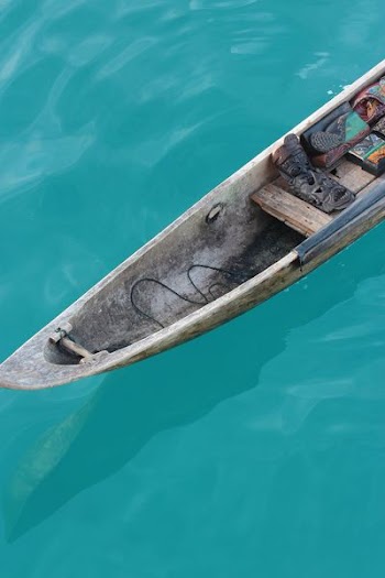 tribal mask on brown boat