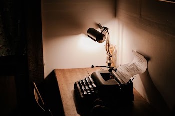 turn-on desk lamp near typewriter